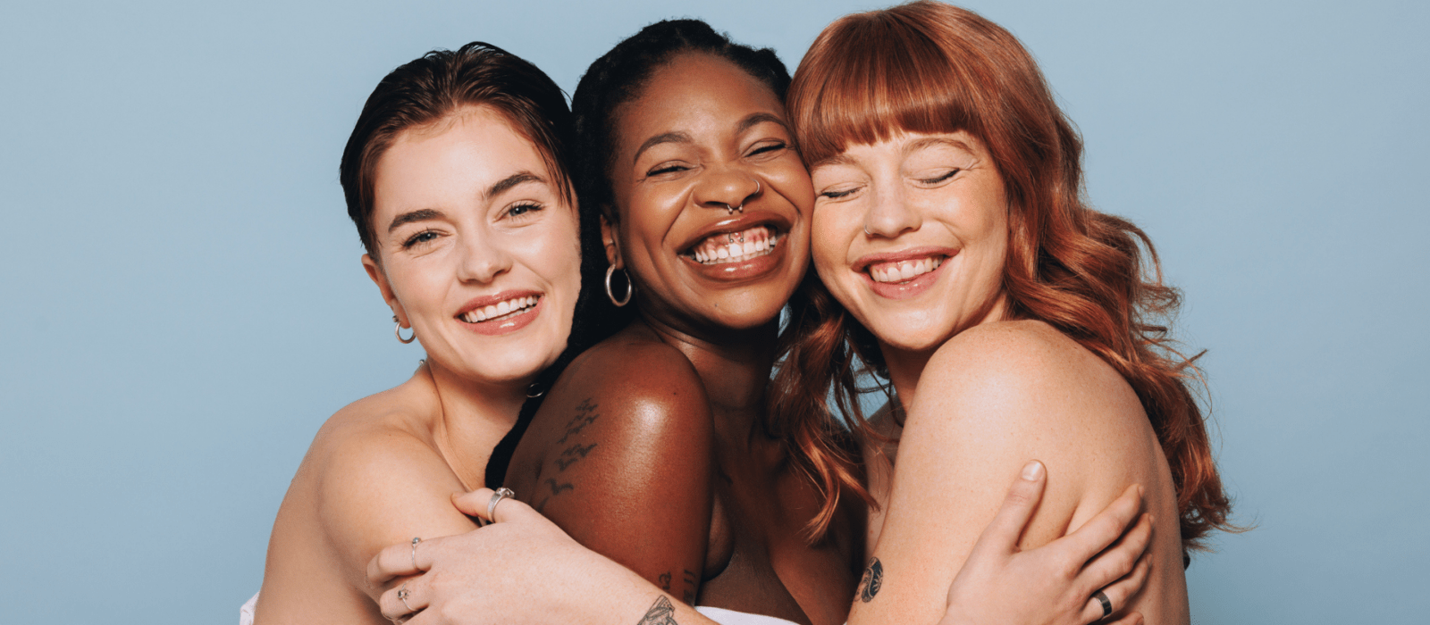 three girls smiling together